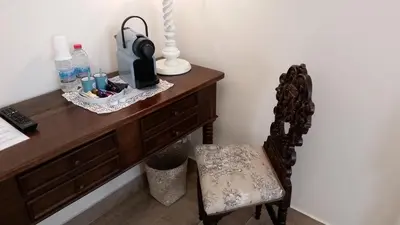 a wooden desk with a chair and a bottle of water at B&B Villa Blanche in Cannes