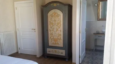 a wooden door in a room with a bedroom at B&B Villa Blanche in Cannes