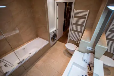 a bathroom with a tub and a toilet and a sink at Imperial Apartment by Connexion in Cannes