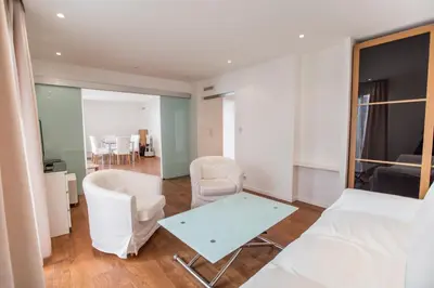 a living room with white furniture and a table at Imperial Apartment by Connexion in Cannes