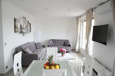 a living room with a couch and a table with fruit on it at 3P lumineux rénové derrière la Croisette in Cannes