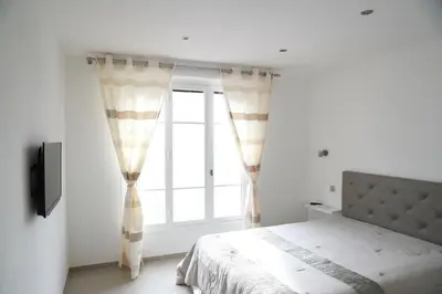 a bedroom with a bed and a window at 3P lumineux rénové derrière la Croisette in Cannes