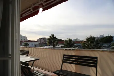 a balcony with two chairs and a table at 3P lumineux rénové derrière la Croisette in Cannes
