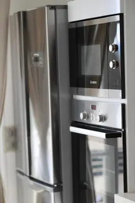 a stainless steel oven with a microwave on top of it at 3P lumineux rénové derrière la Croisette in Cannes