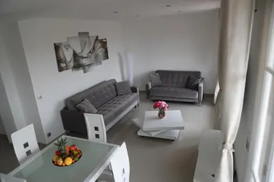 a living room with a couch and a table at 3P lumineux rénové derrière la Croisette in Cannes