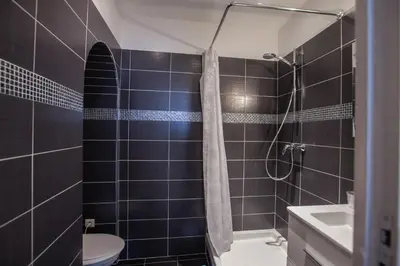 a bathroom with a shower and a toilet and a sink at Appartements Foch in Cannes