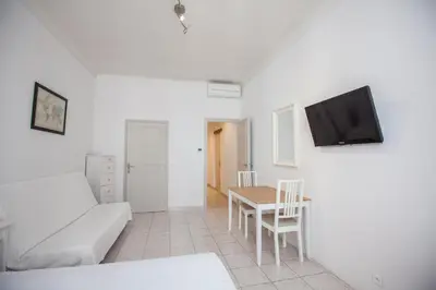 a living room with a couch and a table at Appartements Foch in Cannes