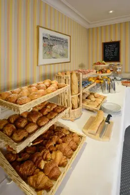a table with many trays of bread and pastries at Hotel Splendid in Cannes