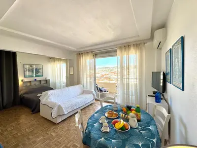 a living room with a table with food on it at Ibis Studio 5380 in Cannes