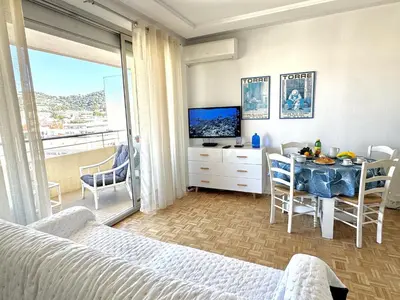 a bedroom with a bed and a table and a television at Ibis Studio 5380 in Cannes