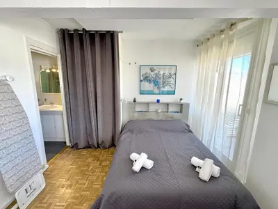 a bedroom with a bed with two teddy bears on it at Ibis Studio 5380 in Cannes