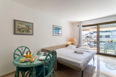 a room with a table and a bed and a table and chairs at Résidence Gray d'Albion Studio BRA507 in Cannes