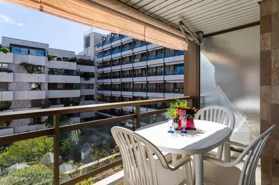 a balcony with a table and chairs and a building at Résidence Gray d'Albion Studio BRA507 in Cannes