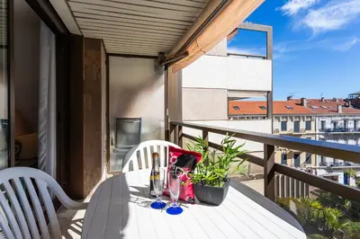 a table on a balcony with a view of a building at Résidence Gray d'Albion Studio BRA507 in Cannes