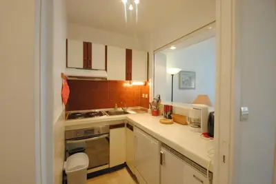 a small kitchen with white cabinets and a sink at Résidence Gray d'Albion Studio BRA507 in Cannes