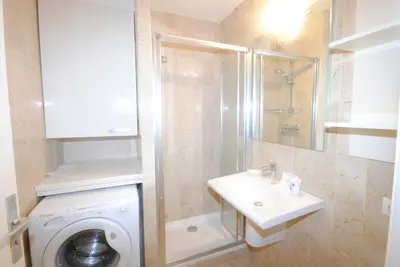 a bathroom with a washing machine and a sink at Résidence Gray d'Albion Studio BRA507 in Cannes