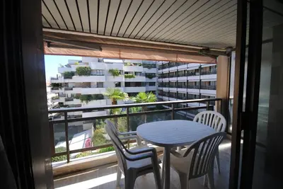 a balcony with a table and chairs and a building at Résidence Gray d'Albion Studio BRA507 in Cannes
