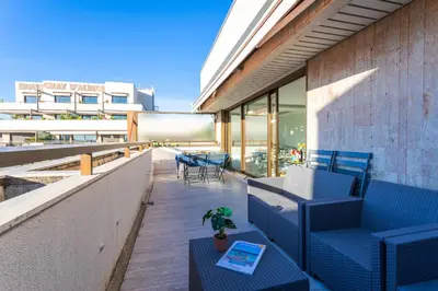 a balcony with blue chairs and tables on a building at Résidence Gray d'Albion appartement DEL562 in Cannes