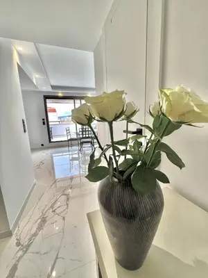 a vase with flowers on a table in a room at Résidence Gray d'Albion appartement DEL562 in Cannes