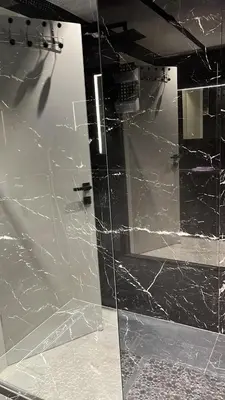 a glass door in a bathroom with black marble at Résidence Gray d'Albion appartement DEL562 in Cannes