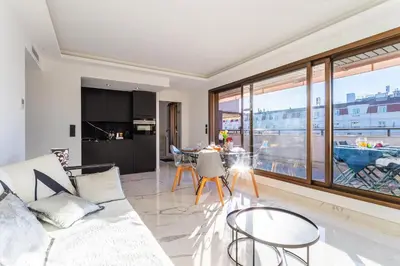 a living room with a white couch and a large window at Résidence Gray d'Albion appartement DEL562 in Cannes