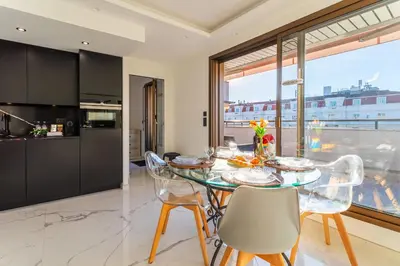 a kitchen and dining room with a glass table and chairs at Résidence Gray d'Albion appartement DEL562 in Cannes