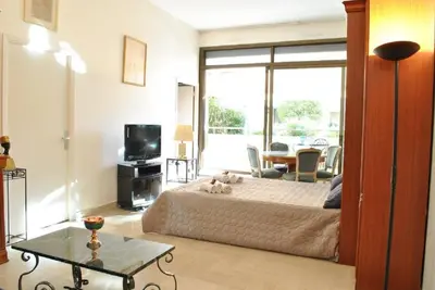 a living room with a couch and a tv at Résidence Gray d'Albion Studio LOU511 in Cannes