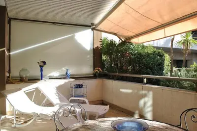 a patio with a table and chairs and a tub at Résidence Gray d'Albion Studio LOU511 in Cannes