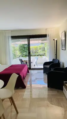 a bedroom with a bed and a living room at Résidence Gray d'Albion Studio ROU503 in Cannes