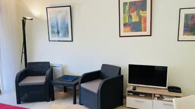 a living room with two chairs and a television at Résidence Gray d'Albion Studio ROU503 in Cannes