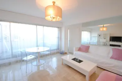 a living room with a white couch and a table at Résidence Gray d'Albion 2P LIU5376 in Cannes