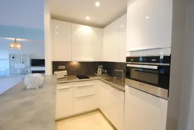 a white kitchen with white cabinets and appliances at Résidence Gray d'Albion 2P LIU5376 in Cannes
