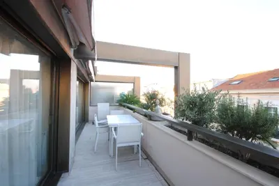 a balcony with a table and chairs on a building at Résidence Gray d'Albion 2P LIU5376 in Cannes