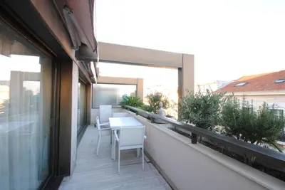 a balcony with a table and chairs on a building at Résidence Gray d'Albion 2P LIU5376 in Cannes