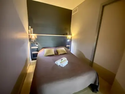 a small bedroom with a bed with two pillows at Résidence Gray d'Albion 2P 5402 in Cannes