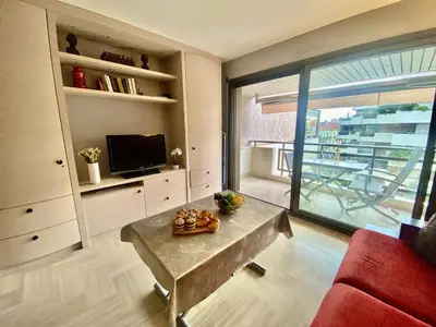 a living room with a table and a large window at Résidence Gray d'Albion 2P 5402 in Cannes