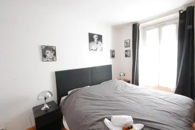 a bedroom with a large bed and a window at Les Serbes 2P RET29 in Cannes