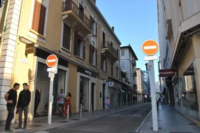 a group of people walking down a street with street signs at Les Serbes 2P RET29 in Cannes