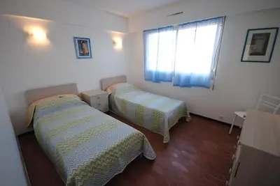 a room with two beds and a window in it at Le Minerve 3P DEB5515 in Cannes