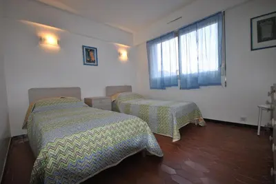 a bedroom with two beds and a window at Le Minerve 3P DEB5515 in Cannes