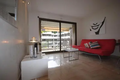 a living room with a red couch and a table at Résidence Gray d'Albion 2P NAP558 in Cannes