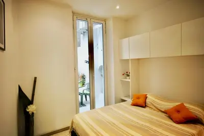 a bedroom with a bed with orange pillows on it at Le Gambetta 2P 262 in Cannes