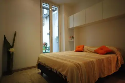 a bedroom with a bed with orange pillows on it at Le Gambetta 2P 262 in Cannes