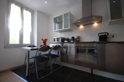 a kitchen with two chairs and a table in it at Le Gambetta 2P 262 in Cannes