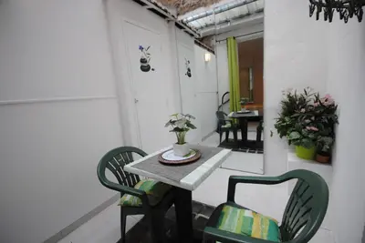 a patio with a table and chairs in a room at Le Gambetta 2P 262 in Cannes