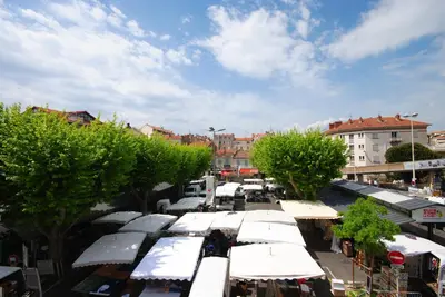 an overhead view of a market with many white stalls at Le Gambetta 2P 262 in Cannes
