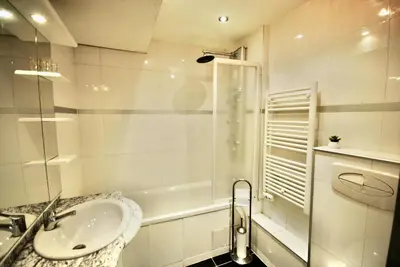 a white bathroom with a sink and a shower at Le Gambetta 2P 262 in Cannes