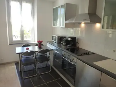 a kitchen with a counter and stools in it at Le Gambetta 2P 262 in Cannes