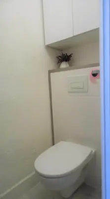 a bathroom with a white toilet and a white cabinet at CANNES plage 2mn/45m2/vue mer/inernet/clim/parking privé in Cannes