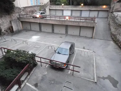 a car parked in a parking lot next to a building at CANNES plage 2mn/45m2/vue mer/inernet/clim/parking privé in Cannes
